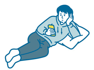 A man lying down and looking at a smartphone