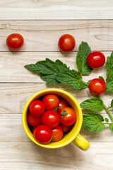 Fototapeta na wymiar cherry tomatoes on wooden table background