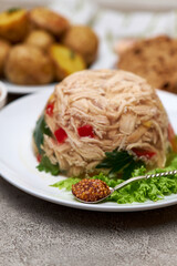 Delicious chicken aspic on a plate on concrete table