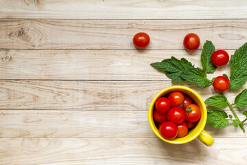 cherry tomatoes on wooden table background