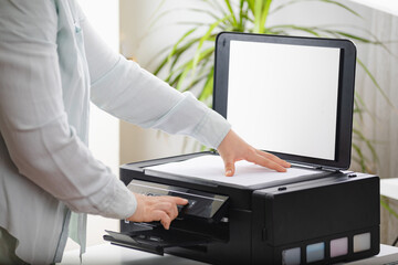 Office work. Secretary woman making a photocopy of important documents. Office manager using...