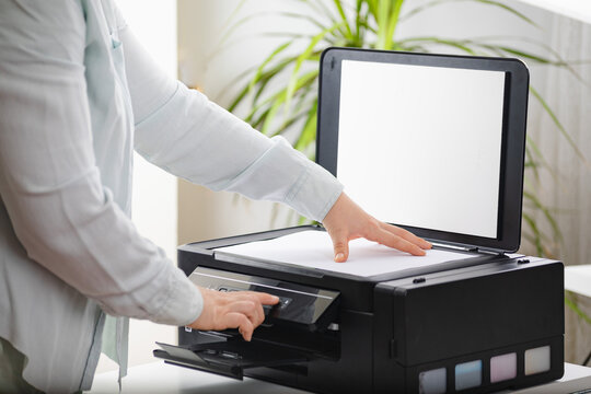 Office work. Secretary woman making a photocopy of important documents. Office manager using printer, scanner or laser copy machine.