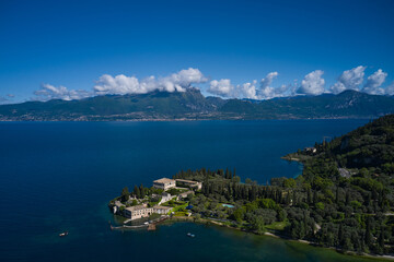 Fototapeta na wymiar Aerial view of Parco Baia delle Sirene, Lake Garda, Italy. Top view of baia delle sirene on the coastline of Lake Garda. Panorama of punta san vigilio.