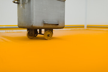 metal cart to transport meat in the meat preparation hall placed on a yellow floor