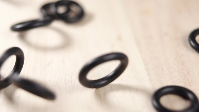 Rubber gaskets for plumbing seals falling in slow motion close-up. Sealing rings. Hydraulic repair spare