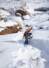 Naklejka na ściany i meble Skier climb at high snowy mountains