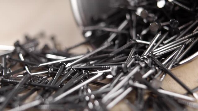 Metal steel nails falling in slow motion. Macro. Furniture assembly tool