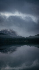Fototapeta premium lakeview of mountains covered in morning fog