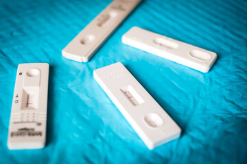 Fototapeta premium COVID-19 virus disease diagnostic, person holding coronavirus test cassette, rapid strep kit, quick antigen detection testing. Defocused