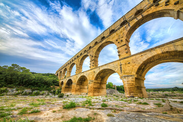 Obraz premium The Aqueduct Pont du Gard Crossing the Gardon River, Occitanie, France