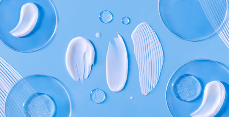 banner smear of cream round transparent drop of banner transparent gel serum in a petri dish on a blue background