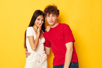 Naklejka premium cute young couple Friendship posing hugs together yellow background unaltered