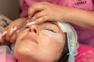 Obraz na płótnie Canvas Eyelash extension procedure. Woman eye with long eyelashes. lashes, close up, macro, selective focus.