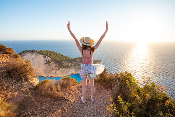 Woman tourist in Zakynthos, Greece admiring the Navagio beach
