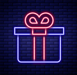 Glowing neon line Gift box icon isolated on brick wall background. Colorful outline concept. Vector