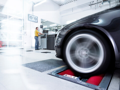Car tire test with technician at automobile industry