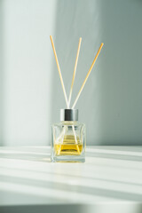 Aroma sticks for spa in a bottle on a white table. Minimalism. - 485516456