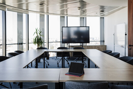 Empty conference room with laptop on table in office