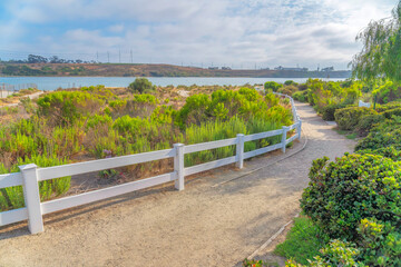 Dirt trail with white fence at Agua Hendionda Lagoon in Carlsbad, San Diego, California
