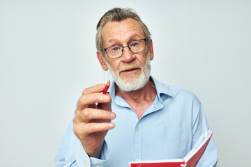 old man writes down emotions in a notebook light background