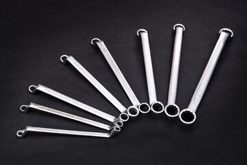 Straight cap key. A set of keys for car repair. Hand tool. Isolated. Black background.