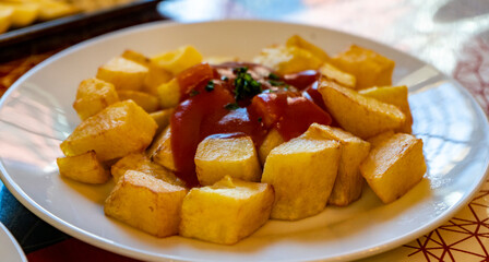 Patatas bravas servidas en un plato listas para comer. 
