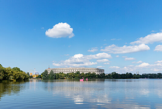 Germany, Bavaria, Nuremberg, Sky over Grosser Dutzendteich lake with Congress Hall in background