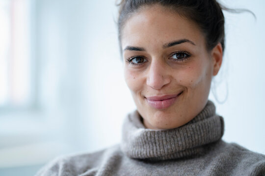 Smiling beautiful woman in turtleneck sweater