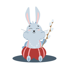Fototapeta na wymiar a small gray easter bunny holding a willow twig in its paw