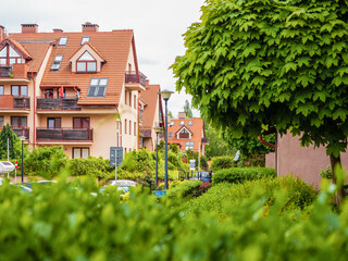 Cityscape of a cozy residential area with modern apartment buildings, new green urban landscape in the city