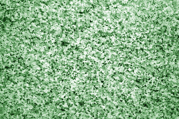 Granite surface as background with blur effect in green tone.