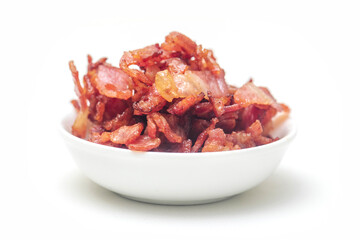 Close up of fried bacon pieces isolated white background.