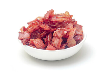 Close up of fried bacon pieces isolated white background.