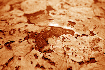 Cork board texture with blur effect in orange tone.