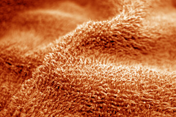 Bath towel texture with blur effect in orange tone.