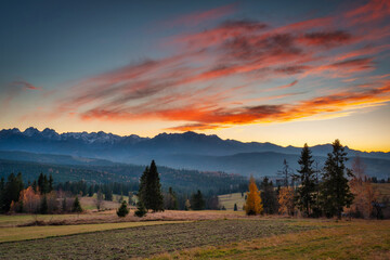 Fototapeta na wymiar Beautiful sunset on the meadow under the Tatra Mountains at autumn. Poland