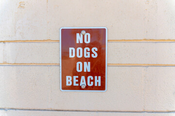 No dogs on beach against the beige wall at San Clemente, Orange County, California