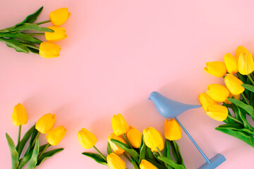bouquet of yellow tulips on a light pink background. Spring flower arrangement. Background for greeting cards, invitations. Conception Day, March 8, Mother's Day. Flat lay