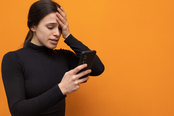 Worried woman portrait looking at smartphone