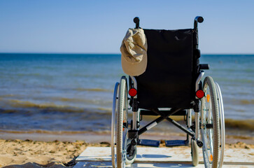 wheelchair on the seashore. disabled person resting on the sea