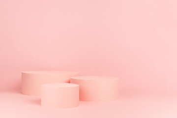 Romantic pastel pink stage with group of three round podiums mockup for presentation cosmetic products, goods, advertising, show on gentle soft light background, copy space.