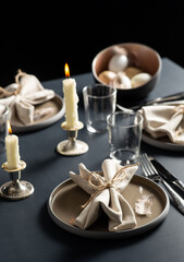 easter, holidays, tradition and object concept - close up of dinner party table serving over black background