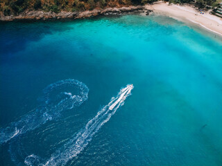 .Top view of the speedboat, leaving trace on the surface of the blue water; vessels concept..