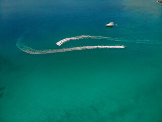 .Top view of the speedboat, leaving trace on the surface of the blue water; vessels concept..