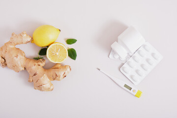 Fototapeta premium ginger, lemon, mint leaves and medicines, treatment and prevention of colds with natural remedies