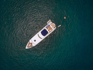 Top view of the luxurious yacht in the vast blue sea; lifestyle concept.