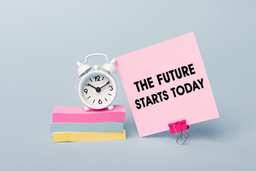 The future starts today - concept of text on pink sticky note. Closeup of a personal agenda. Alarm...