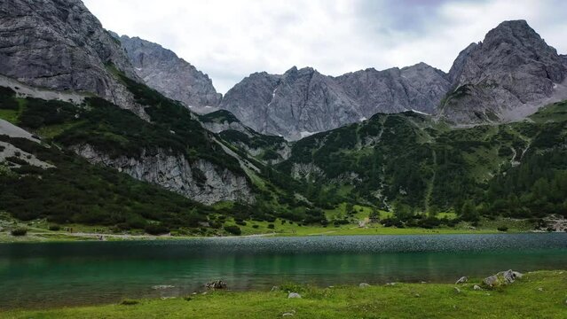Seebensee Lake Austrian Alps grass water aerial mountain peaks