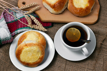 Sweet buns with cottage cheese and a cup of hot tea