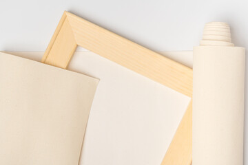 Print photos on canvas, wooden stretcher, canvas roll on white background, top view